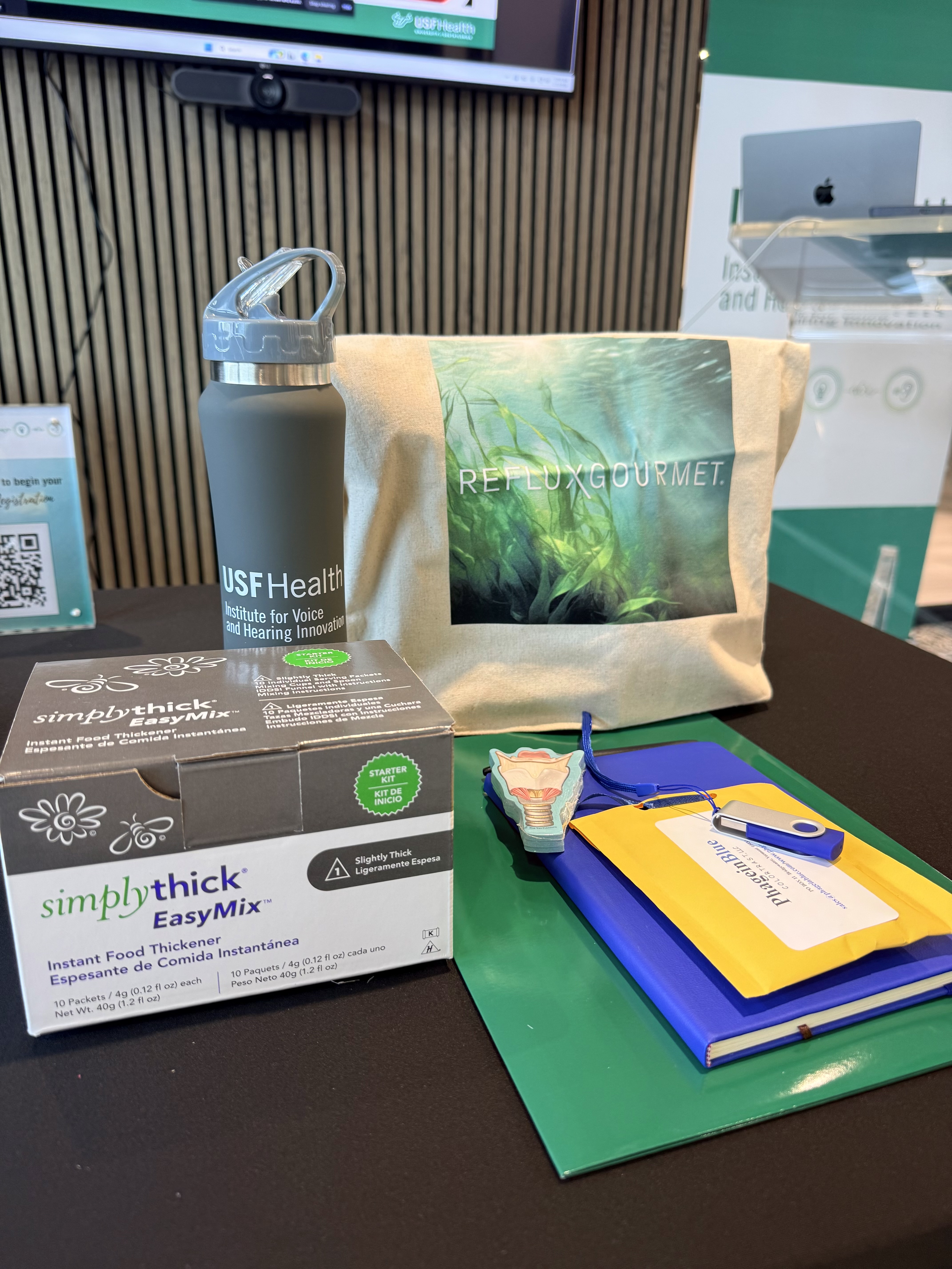 Branded conference merchandise and wellness materials displayed at an event
